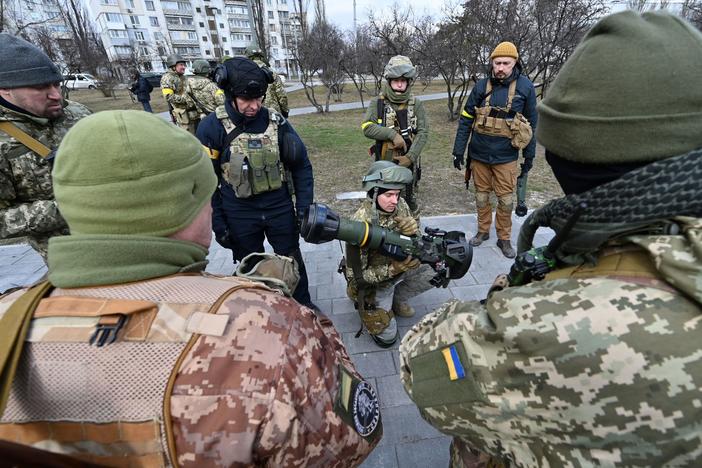 Members of the Ukrainian Territorial Defense Forces examine new armaments including NLAW anti-tank systems and other portable anti-tank grenade launchers, in Kyiv on March 9.