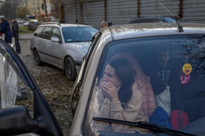 A Ukranian woman sits in a car with her family in Zaporizhzhia on Saturday, after they fled from the Russian-occupied territory of Kherson.