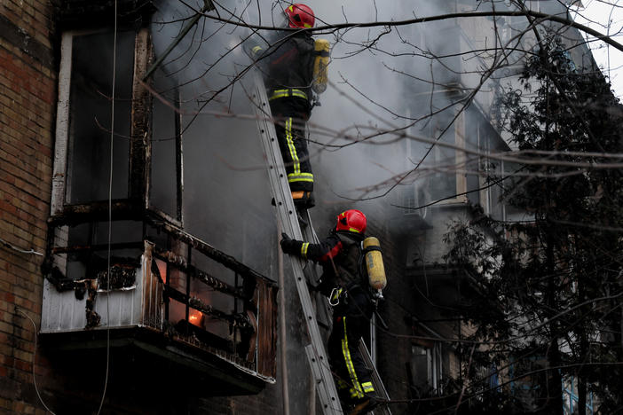 Firefighters work to put out a fire in a residential building hit by a Russian missile strike in Kyiv on Tuesday.