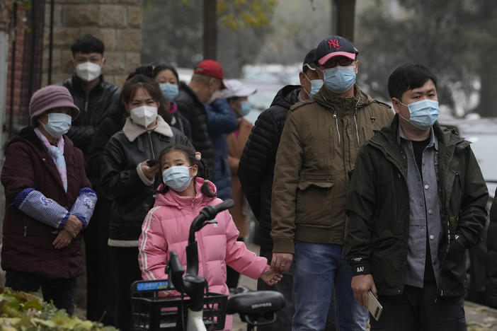 Residents line up for COVID tests in Beijing, Thursday, Nov. 24, 2022. China is expanding lockdowns, including in a central city where factory workers clashed this week with police, as its number of COVID-19 cases hit a daily record.