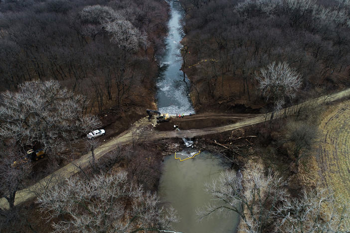 In this photo taken by a drone, cleanup continues in the area where the ruptured Keystone pipeline dumped oil into a creek in Washington County, Kan., on Friday.