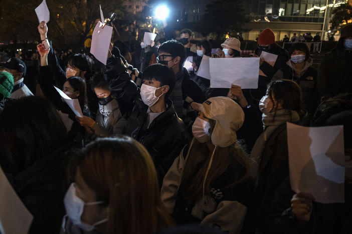 Protesters hold up a white piece of paper against censorship during a protest against China's strict zero COVID measures on November 27, 2022 in Beijing.