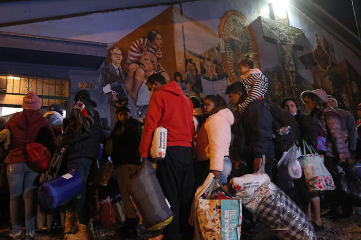 Unsheltered migrants wait for bed space to open for the evening in the gymnasium at Sacred Heart Church after crossing the Rio Grande into the United States in El Paso, Texas, on Thursday.
