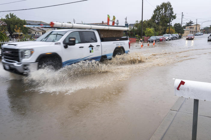 A truck is driven through a flooded intersection of Salinas, Calif., on Tuesday. The first in a week of storms brought gusty winds, rain and snow to California on Tuesday, starting in the north and spreading southward.