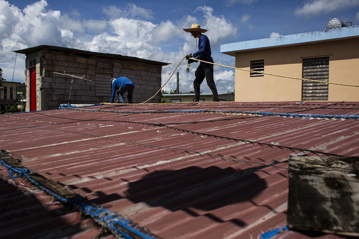 Construction apprentices prepare to replace a damaged roof in the town of Toa Baja, P.R. PRoTechos, the nonprofit they work with, was founded to fix the roofs of people who got little or no government help after Hurricane Maria devastated the island in 2017.