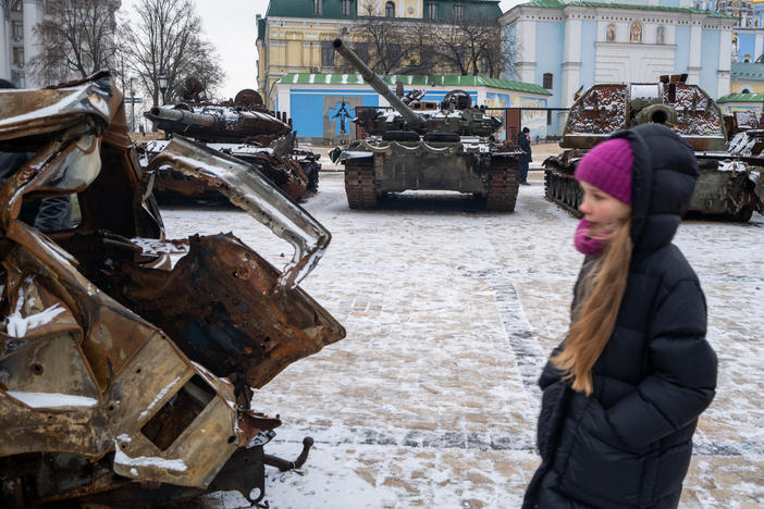 People look at destroyed Russian military vehicles on display in central Kyiv on a snowy afternoon in the capital city on January 9.