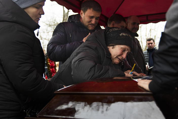 Korenovsky's mother cries over her son's coffin at his funeral on Tuesday.