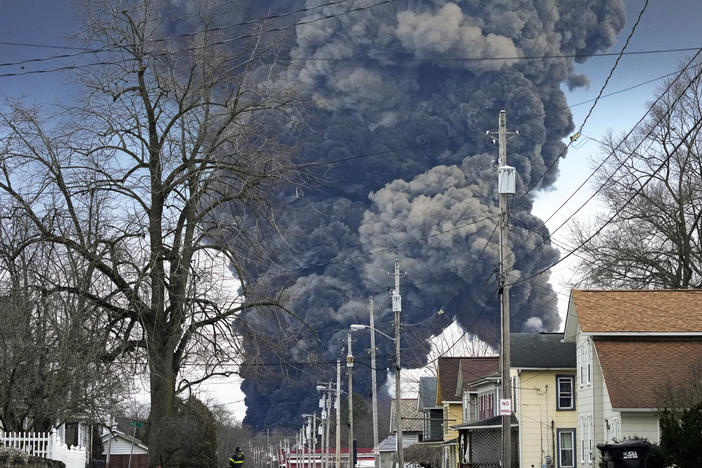 A black plume rises over East Palestine, Ohio, as a result of the controlled detonation of a portion of the derailed Norfolk and Southern trains on Monday.