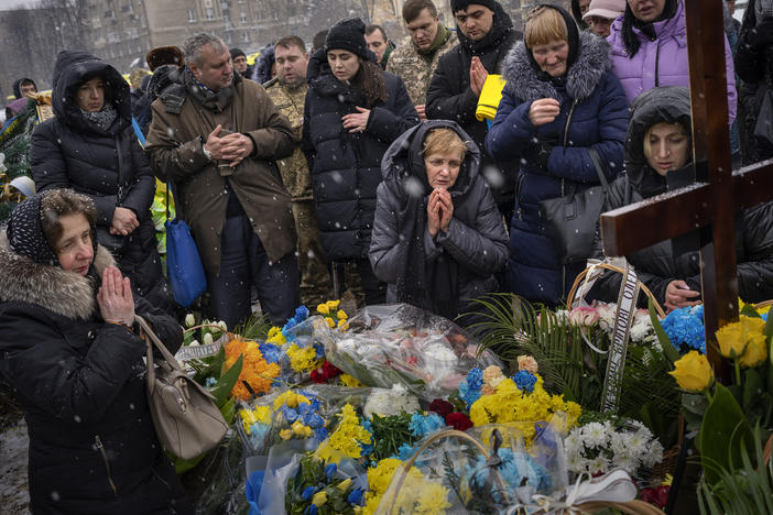 Nadia (center) prays at the grave of her son Oleg Kunynets, a Ukrainian military serviceman who was killed in the east of the country, during his funeral in Lviv, Ukraine, on Feb. 7.
