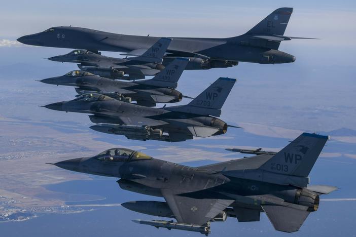 In this photo provided by South Korea Defense Ministry, a U.S. Air Force B-1B bomber, top, flies in formation with U.S. Air Force F-16 fighter jets over the South Korea Peninsula during a joint air drill in South Korea, Sunday, Feb. 19, 2023.