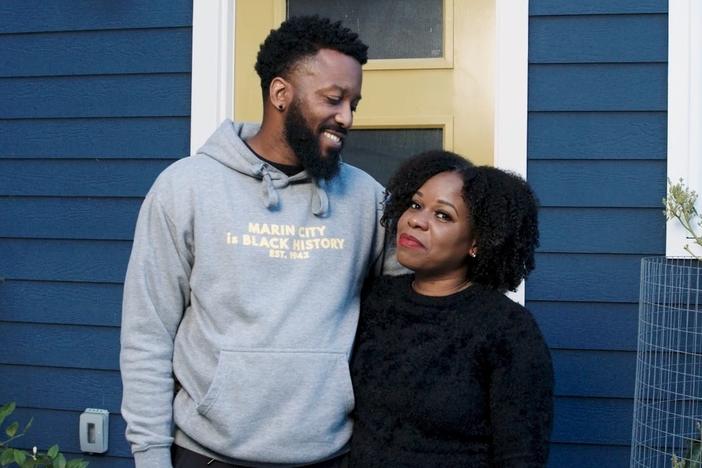 Paul Austin and Tenisha Tate Austin stand in front of their renovated home in Marin City, Calif. The couple settled a federal housing discrimination lawsuit late last month.