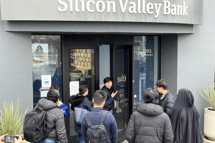 A worker tells people that the Silicon Valley Bank (SVB) headquarters in Santa Clara, Calif., is closed on March 10. Federal regulators took extraordinary measures on Sunday to backstop all deposits at SVB after the lender's spectacular collapse.