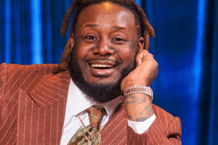 The rapper T-Pain poses with his 2023 album, <em>On Top of the Covers</em>.
