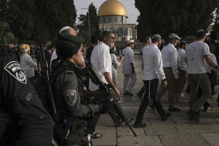 Israeli police escort Jewish visitors marking the holiday of Passover to the Al-Aqsa Mosque compound, known to Muslims as the Noble Sanctuary and to Jews as the Temple Mount, in the Old City of Jerusalem during the Muslim holy month of Ramadan on Sunday, April 9, 2023.