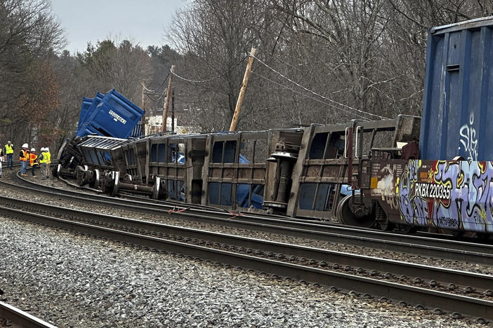 Officials work at the scene of a derailed freight train with no hazardous materials, Thursday, March 23, 2023, in Ayer, Mass.
