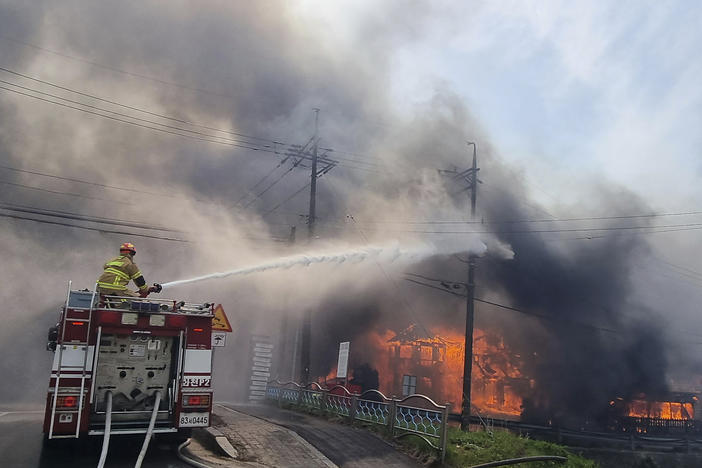 Firefighters work to extinguish a fire in Gangneung, South Korea, Tuesday, April 11, 2023.