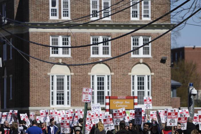 Strikers march in front of Rutgers' buildings in New Brunswick, N.J., this past Monday.