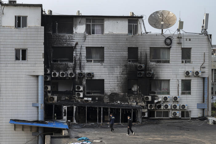 Fire investigators inspect the scene of a deadly fire at the Changfeng Hospital in the Fengtai District on Wednesday in Beijing. At least 29 people died in the fire on Tuesday afternoon, and 12 people have been detained for questioning. The cause of the blaze was unknown at the time the photo was taken.