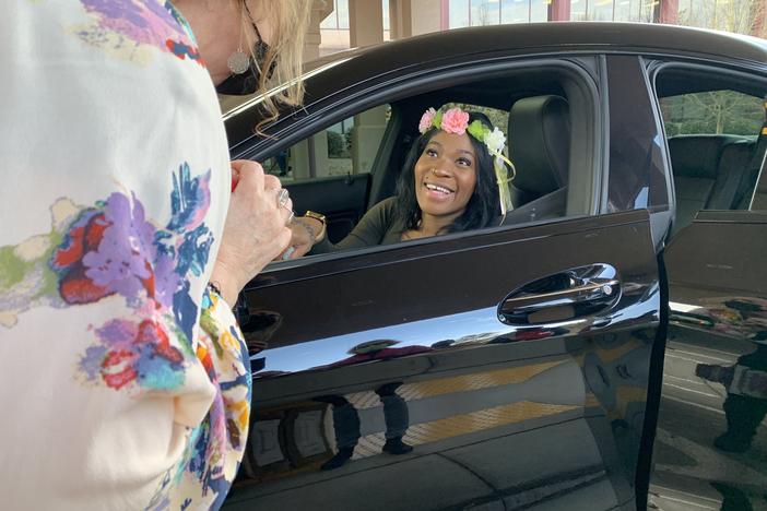 A pregnant military veteran receives a tiara at a 'drive through' baby shower at the VA in Atlanta. Among researchers, there's concern that women veterans may be at <a href="https://reporter.nih.gov/project-details/10314239#details">heightened risk</a> for pregnancy complications, compared to their civilian counterparts.