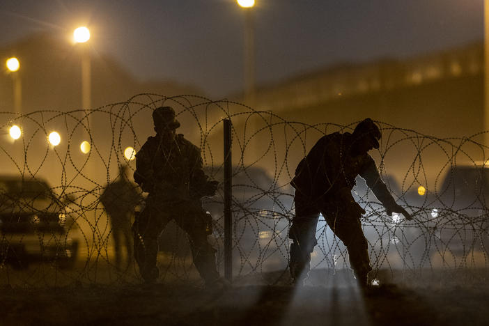 Texas National Guard troops set up razor wire in El Paso, Texas. Officials are anticipating a wave of immigrants on Thursday night, with the end of the U.S. government's COVID-era Title 42 policy.