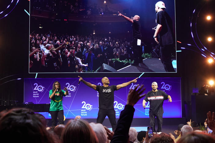 They're hip-hop artists who weave public-health messages into their rhymes: From left: Sister Fa, Darryl "DMC" McDaniels and Ali A.K.A. Mind perform at the Skoll World Forum 2023. During this rap, McDaniels called out: "I'm not afraid of the dark anymore/because I am the light./I'll be there at the start of the war/Because I am the fight."