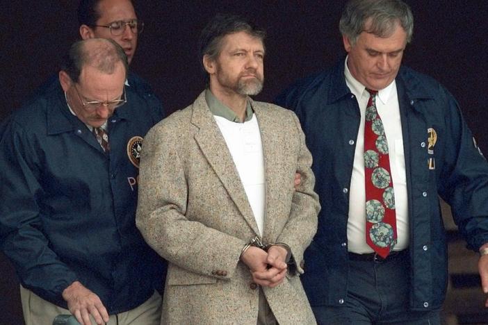 U.S. Marshals prepare to take Theodore Kaczynski down the steps at the federal courthouse to a waiting vehicle on June 21, 1996, in Helena, Mont. A spokesperson for the Bureau of Prisons told The Associated Press on Saturday that Kaczynski, known as the "Unabomber," has died in federal prison.