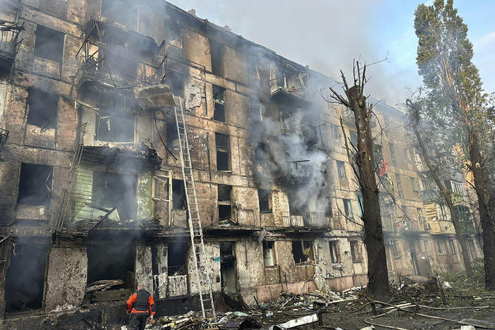 In this photo released by Dnipro Regional Administration, emergency workers extinguish a fire after missiles hit a multi-story apartment building in Kryvyi Rih, Ukraine, Tuesday, June 13, 2023.