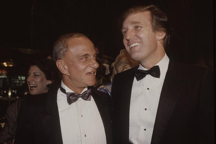 Roy Cohn (left) and Donald Trump attend the Trump Tower opening in New York City in October 1983.
