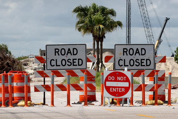 Florida Gov. Ron DeSantis has approved a plan to use phosphogypsum, a radioactive waste material, in "demonstration projects." Here, signs block a roadway in Boca Raton during a construction project in 2021.
