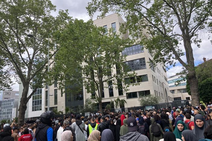 A crowd gathers in front of the Ibn Badis mosque where mourners gathered to pay respects Saturday in Nanterre, France.