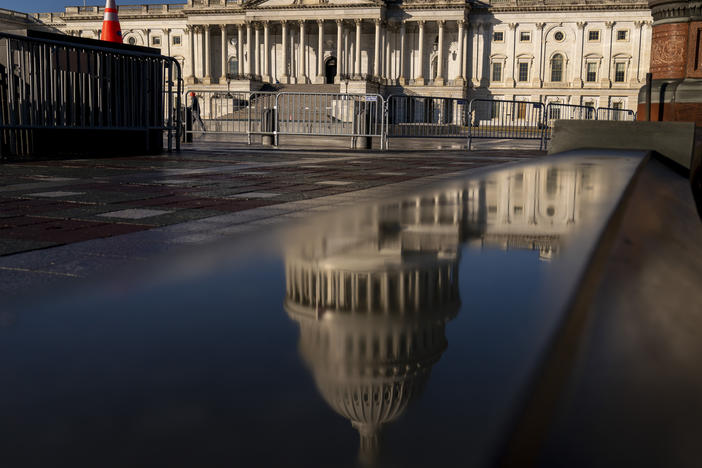 The Dome of the U.S. Capitol Building is visible in a reflection on Capitol Hill on Jan. 23, 2023.