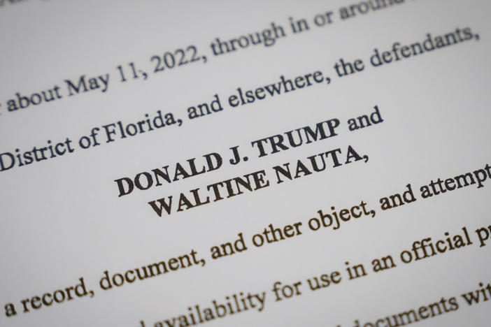 Pages from the unsealed federal indictment of former President Donald Trump. On Monday he asked a Florida judge to delay his trial. Prosecutors asked for it to begin in December.