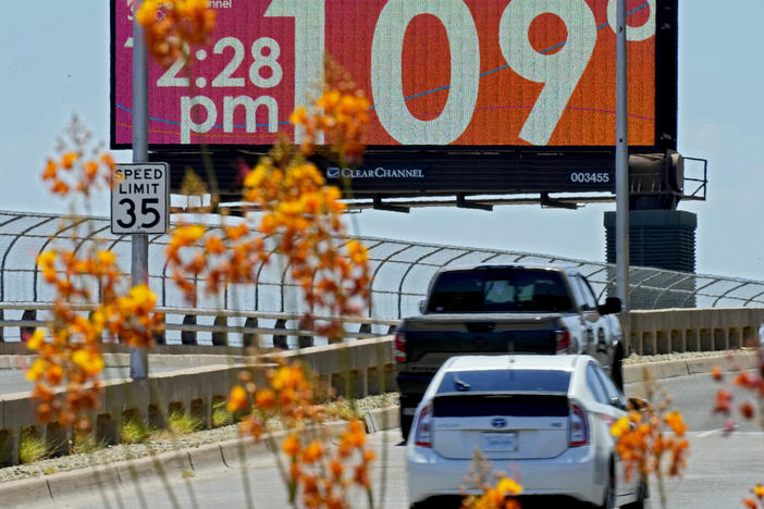 A digital billboard displays an unofficial temperature, Monday, July 17, 2023, in downtown Phoenix.