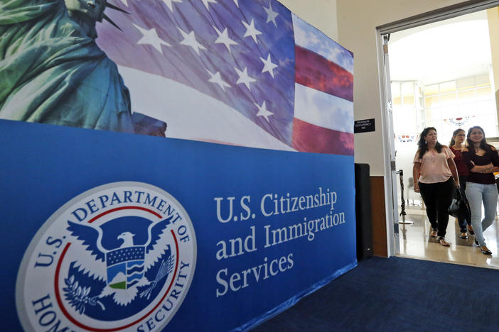 FILE - In this Aug. 17, 2018, file photo, people arrive before the start of a naturalization ceremony at the U.S. Citizenship and Immigration Services Miami Field Office in Miami. One supposed feature of the U visa program is a faster track to citizenship. (AP Photo/Wilfredo Lee, File)