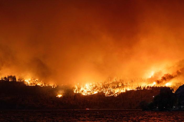 The McDougall Creek wildfire burns in the hills West Kelowna, British Columbia, Canada, on Thursday as seen from Kelowna.