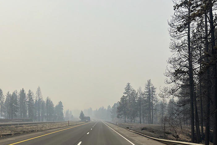 This photo provided by WSDOT East (Washington State of Transportation) smoke from wildfires fill the sky at Salnave/SR 902 interchange in Spokane County, Wash., on Saturday.