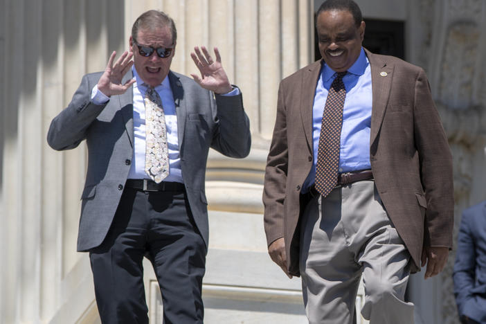 Rep. Neal Dunn, R-Fla., left, and former Rep. Al Lawson, D-Fla., center, are seen exiting the Capitol in Washington on June 15, 2018. After redistricting changed Florida's congressional districts, Dunn defeated Lawson in the 2022 election.