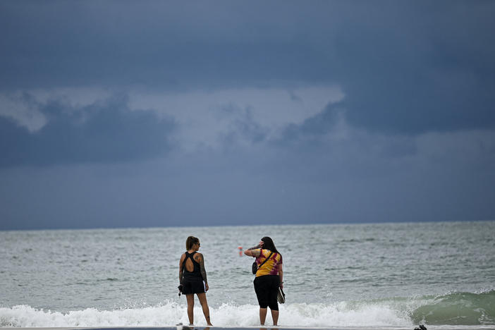 People are shown at the beach in Tampa, Florida, on Tuesday, Aug. 29, 2023 as the city prepares for Hurricane Idalia.