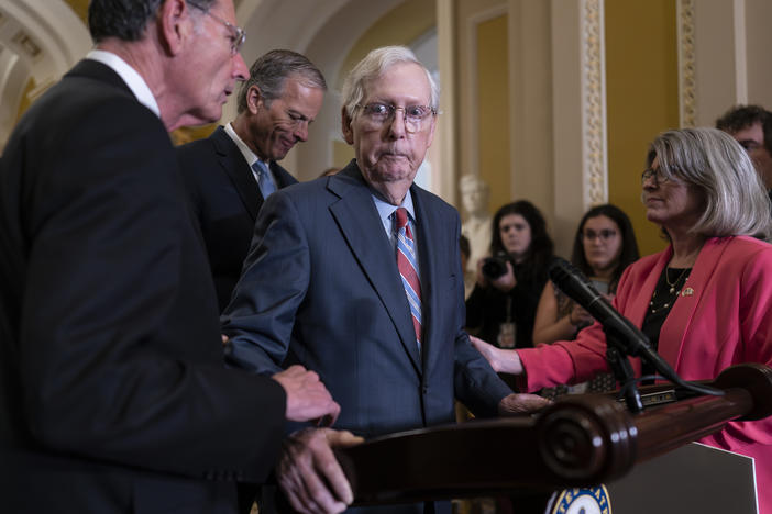 Senate Minority Leader Mitch McConnell, R-Ky., center, is helped by, from left, Sen. John Barrasso, R-Wyo., Sen. John Thune, R-S.D., and Sen. Joni Ernst, R-Iowa, after the 81-year-old GOP leader froze at the microphones as he arrived for a news conference, at the Capitol in Washington on July 26.