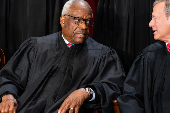 Associate Justice Clarence Thomas, left, talks to Chief Justice John Roberts during the formal group photograph at the Supreme Court in Washington, D.C., on Oct. 7, 2022.