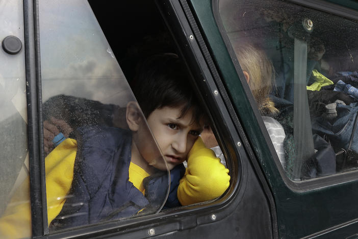 An ethnic Armenian boy from Nagorno-Karabakh looks on from a car upon arrival in Armenia's Goris, in the Syunik region, Armenia, on Monday. Thousands of Armenians have streamed out of Nagorno-Karabakh after the Azerbaijani military reclaimed full control of the breakaway region last week.