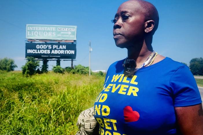 Memphis hairstylist and abortion rights advocate Queen visits a new billboard on Interstate 55 in Arkansas, placed by the group Shout Your Abortion. She says messages such as "God's Plan Includes Abortion" give "courage" and "strength" to those traveling on this road to the closest abortion clinic for thousands of southern women.