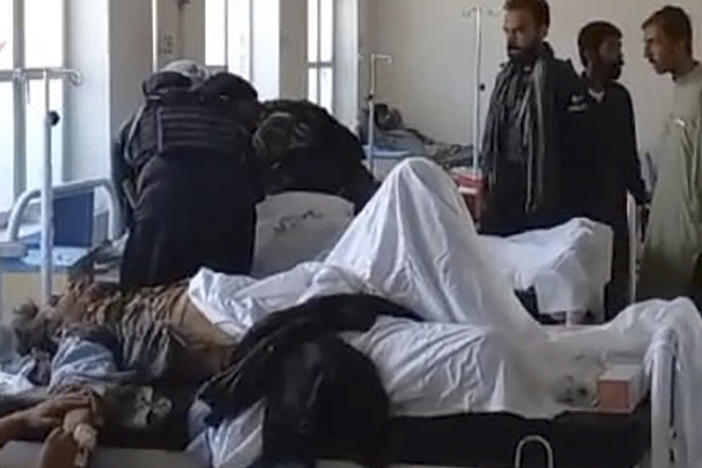 In this photo provided by the District Police Office, injured victims of bomb explosion are treated at a hospital, in Mastung near Quetta, Pakistan