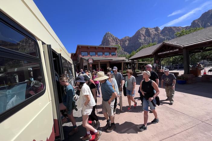 Tourists board a shuttle into Zion National Park, in Utah. The state government will pay for the park to stay open during the government shutdown, in order to keep tourist revenue flowing to nearby towns.
