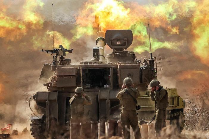 An Israeli army self-propelled howitzer fires rounds near the border with Gaza in southern Israel on Wednesday.