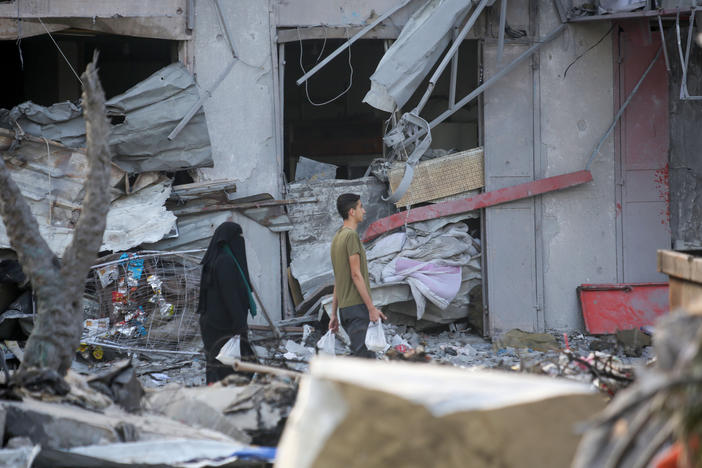 Palestinian citizens inspect damage to their homes caused by Israeli airstrikes on Saturday in Gaza City, Gaza. Many Gazan citizens have fled to the south following warnings from the Israeli government to do so.
