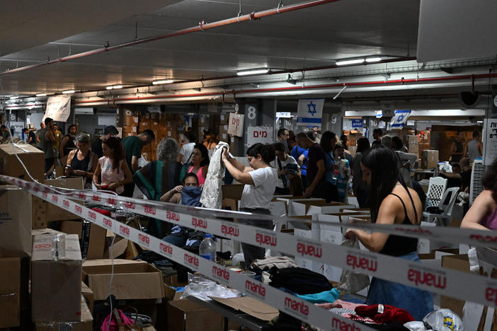 In the underground parking lot at the Expo Tel Aviv International Convention Center, thousands of volunteers help sort and distribute baby clothes, books, winter clothes, and more.