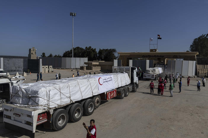 Aid convoy trucks cross the Rafah border from the Egyptian side on Saturday in North Sinai, Egypt.