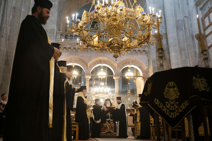 A memorial and prayer service at the Church of the Holy Sepulchre in Jerusalem is held in honor of the victims of an Israeli airstrike at a Gaza church. Bottom left: People attend the special prayer. Bottom right: A man takes communion before the prayer.