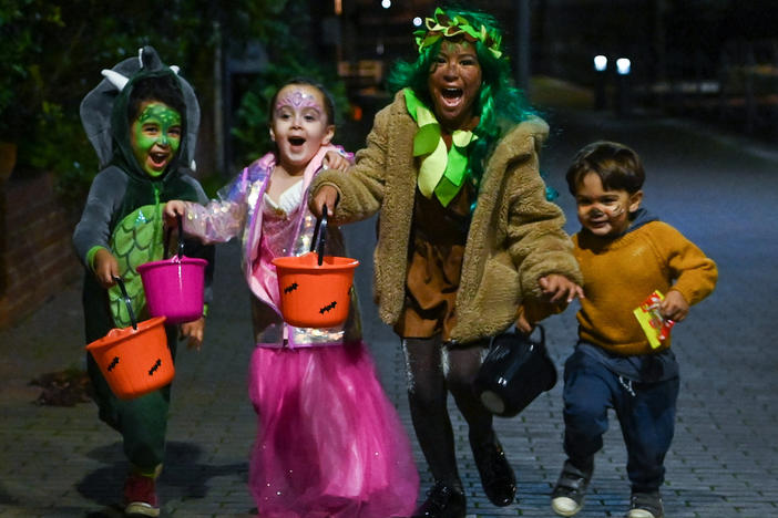 Halloween lets children bring fantasy play into the real world, all while building a sense of community. Here, kids go trick-or-treating during Halloween in  London in 2020.